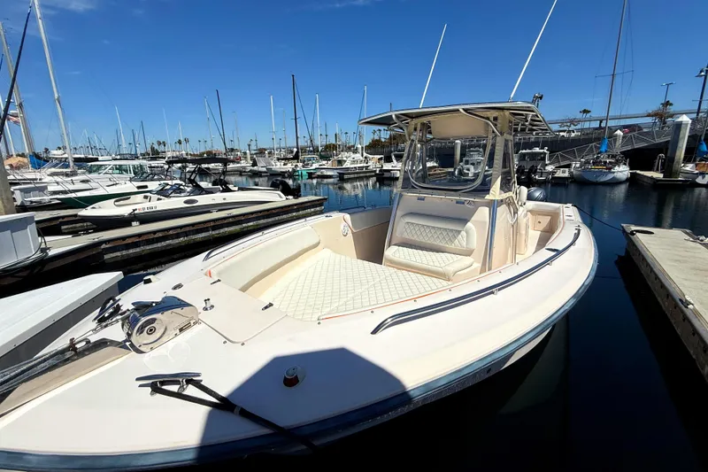 Slide: The Image of 2005 Grady-White Bimini 306 boat docked in a marina under clear blue skies. - 3