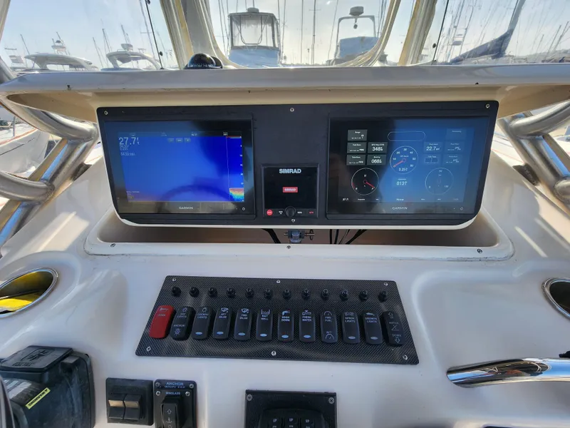 Slide: The Image of Control panel of 2005 Grady-White Bimini 306 boat with navigation screens. - 32