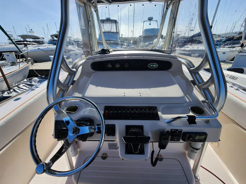Slide: The Image of 2005 Grady-White Bimini 306 boat helm with steering wheel and controls at marina. - 33