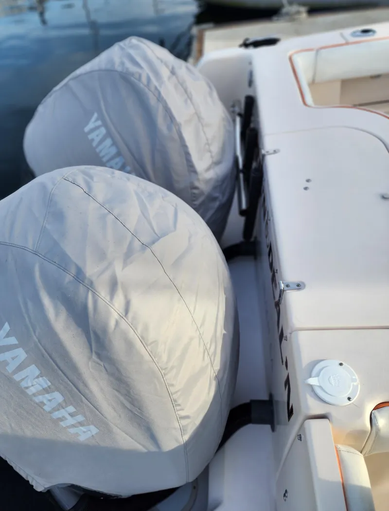Slide: The Image of 2005 Grady-White Bimini 306 with Yamaha engines, docked, featuring covered outboard motors. - 37