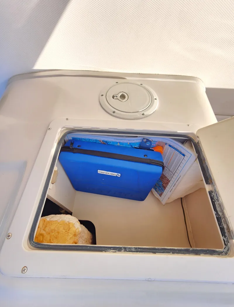 Slide: The Image of Storage compartment on a 2005 Grady-White Bimini 306 boat, containing various items. - 39