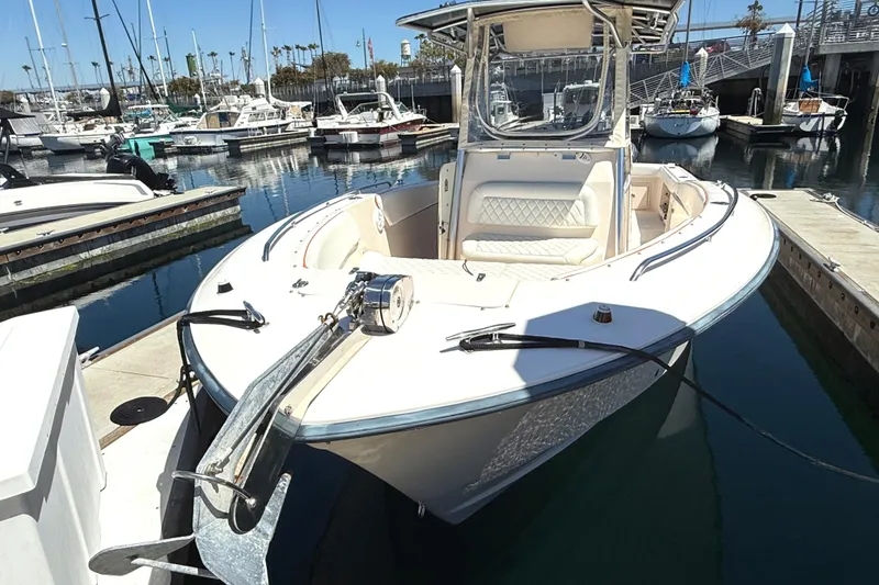 Slide: The Image of 2005 Grady-White Bimini 306 boat docked at marina, front view. - 4