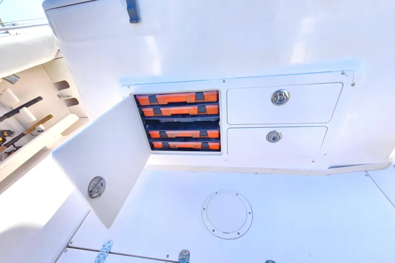 Slide: The Image of 2005 Grady-White Bimini 306 boat storage compartments with tackle boxes and drawers. - 43