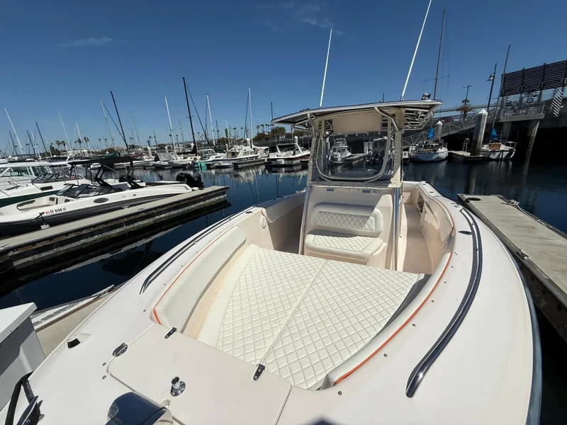 Slide: The Image of 2005 Grady-White Bimini 306 boat docked in marina, featuring spacious seating and sleek design. - 5