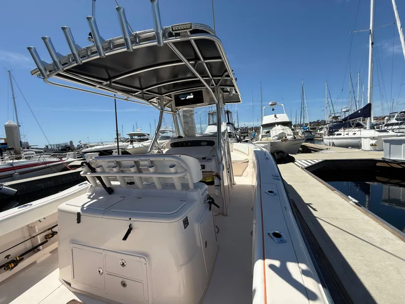 Slide: The Image of 2005 Grady-White Bimini 306 boat docked at marina under clear blue sky. - 8