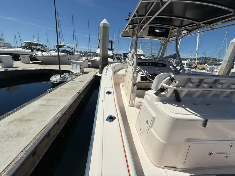 Slide: The Image of 2005 Grady-White Bimini 306 boat docked at marina under clear blue sky. - 9