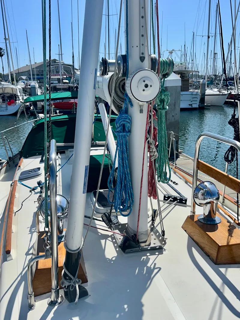Slide: The Image of 1999 Pacific Seacraft 40 Voyagemaker sailboat docked at marina with green canopy. - 12