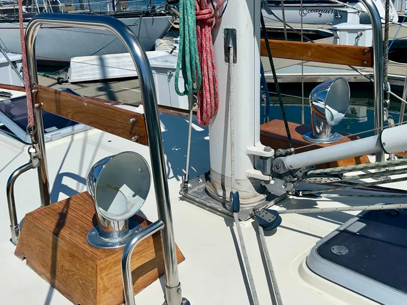 Slide: The Image of Cockpit of 1999 Pacific Seacraft 40 Voyagemaker sailboat, featuring steering wheel and navigation equipment. - 13