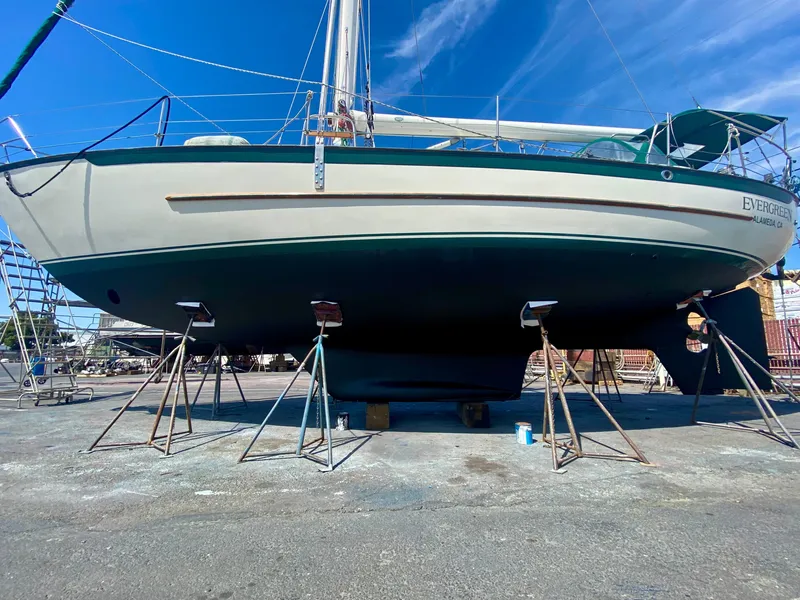 Slide: The Image of 1999 Pacific Seacraft 40 Voyagemaker sailboat docked at marina under clear blue sky. - 2