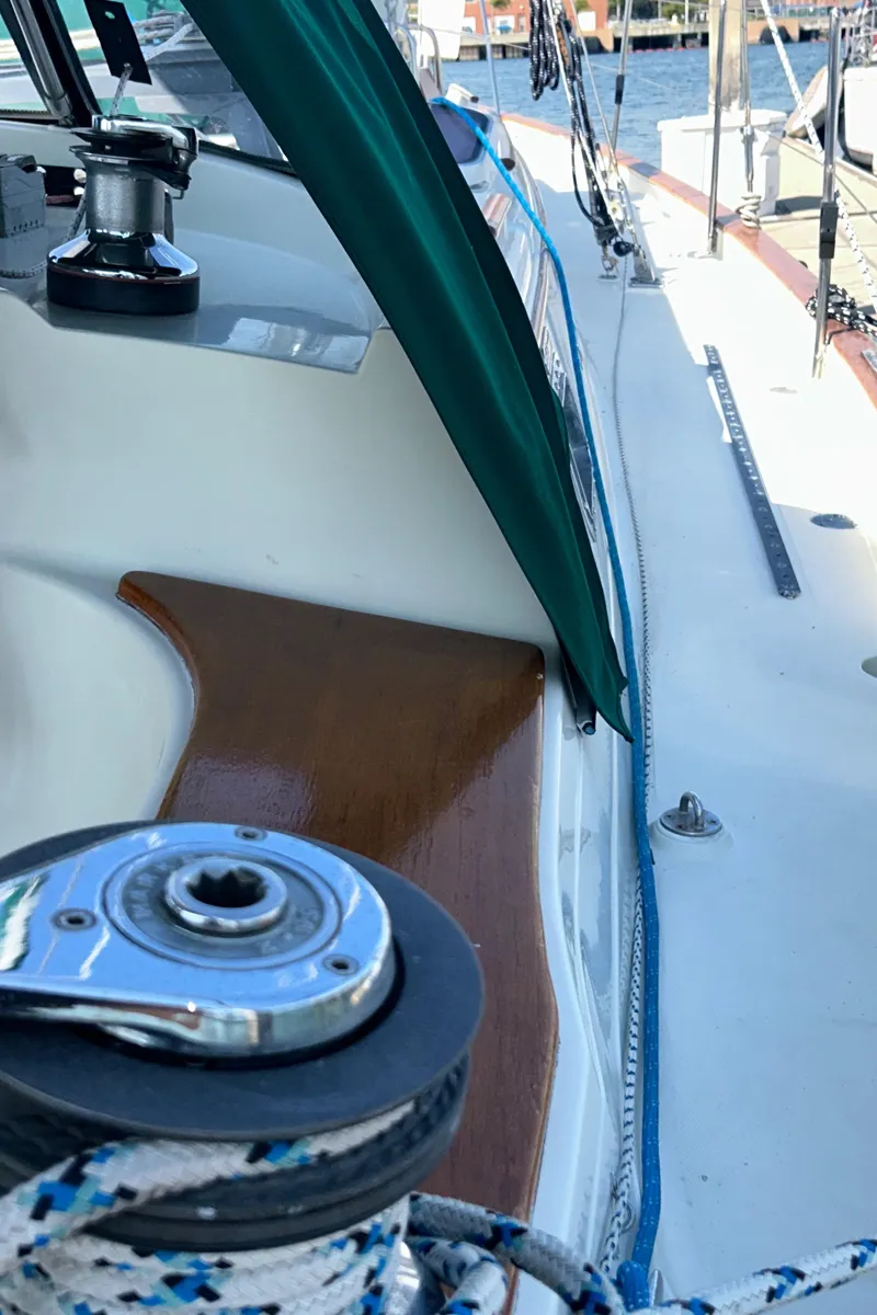 Slide: The Image of Interior of 1999 Pacific Seacraft 40 Voyagemaker with TV and green seating. - 21