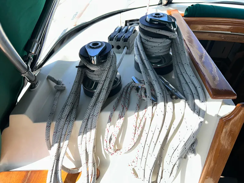 Slide: The Image of Navigation station in 1999 Pacific Seacraft 40 Voyagemaker with wood finish and teal cushions. - 22