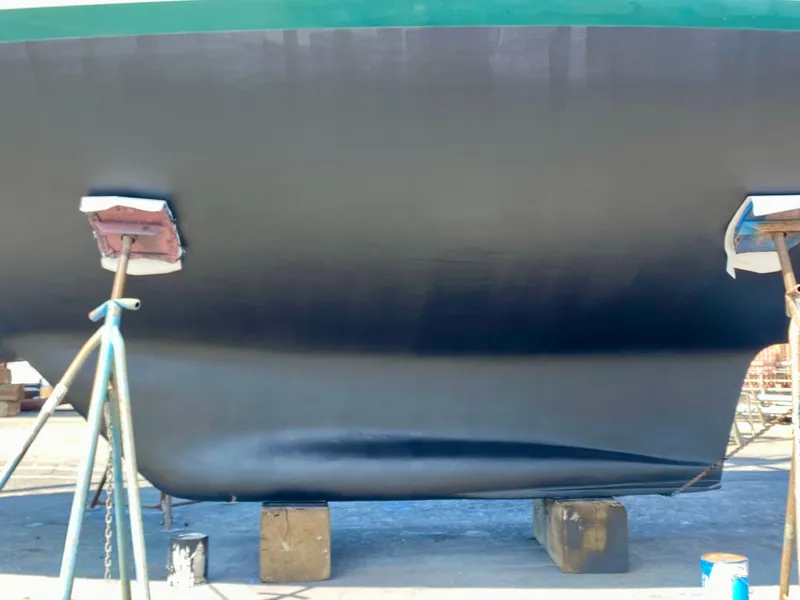 Slide: The Image of 1999 Pacific Seacraft 40 Voyagemaker sailboat on stands, under clear blue sky. - 3