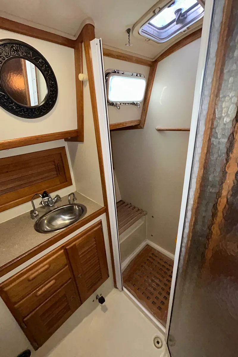 Slide: The Image of 1999 Pacific Seacraft 40 Voyagemaker sailboat deck with winch and ropes. - 38