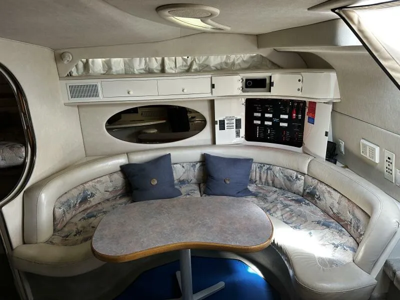 Slide: The Image of Interior of 1996 Sea Ray 400 Express Cruiser with curved seating and table. - 11