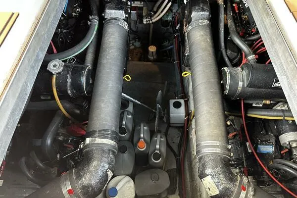 Slide: The Image of Engine compartment of a 1996 Sea Ray 400 Express Cruiser with visible components and hoses. - 14