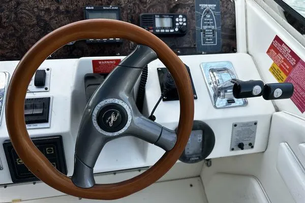 Slide: The Image of 1996 Sea Ray 400 Express Cruiser helm with wooden steering wheel and control panel. - 15