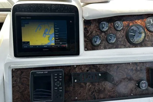 Slide: The Image of Dashboard of a 1996 Sea Ray 400 Express Cruiser with navigation and control instruments. - 16