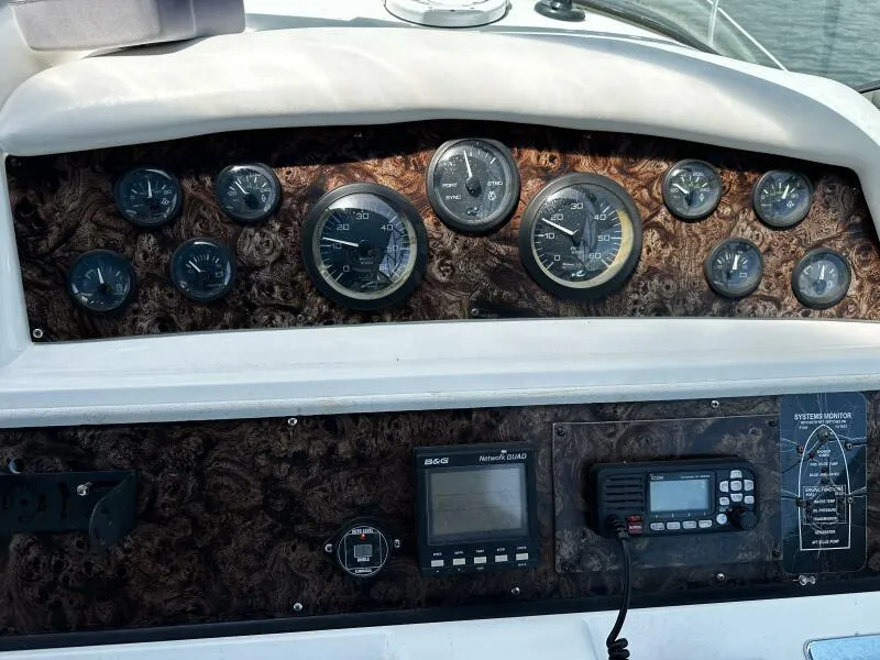 Slide: The Image of Control panel of a 1996 Sea Ray 400 Express Cruiser with gauges and navigation equipment. - 17