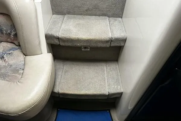 Slide: The Image of Interior steps of a 1996 Sea Ray 400 Express Cruiser with carpeted finish. - 19