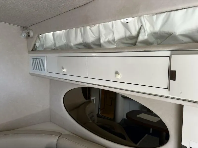 Slide: The Image of Interior of 1996 Sea Ray 400 Express Cruiser with white cabinetry and oval mirror. - 20