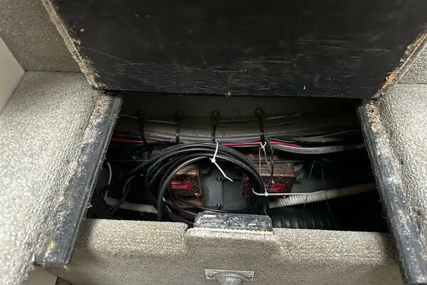 Slide: The Image of Electrical compartment of a 1996 Sea Ray 400 Express Cruiser with visible wiring. - 29