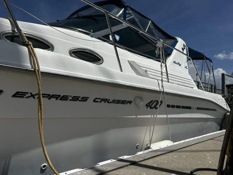 Slide: The Image of 1996 Sea Ray 400 Express Cruiser docked under clear blue sky. - 3