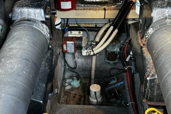 Slide: The Image of Engine compartment of a 1996 Sea Ray 400 Express Cruiser, showing hoses and mechanical components. - 30