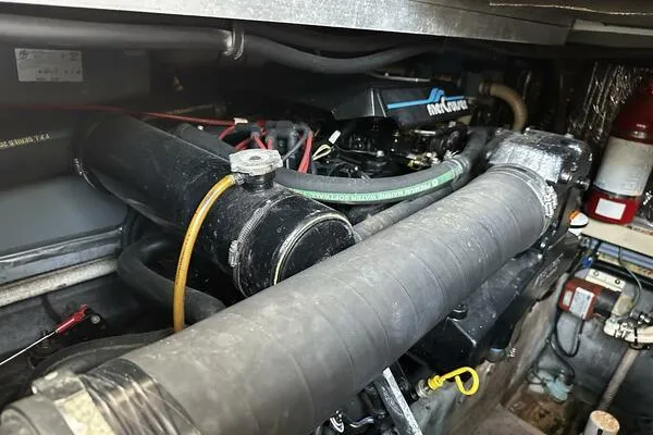 Slide: The Image of Engine compartment of a 1996 Sea Ray 400 Express Cruiser with visible hoses and components. - 31