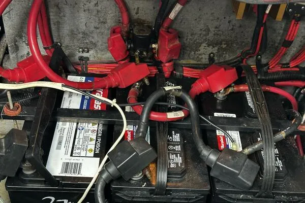 Slide: The Image of Battery compartment of a 1996 Sea Ray 400 Express Cruiser with red and black cables. - 33