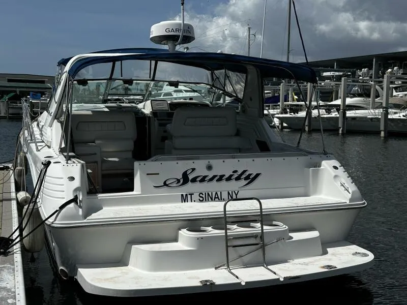 Slide: The Image of 1996 Sea Ray 400 Express Cruiser docked, named "Sanity," at a marina in Mt. Sinai, NY. - 4