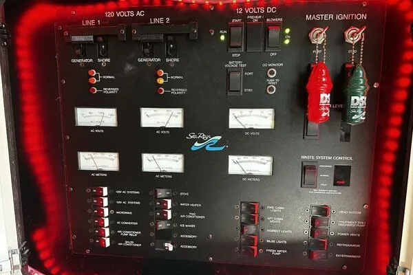 Slide: The Image of Control panel of a 1996 Sea Ray 400 Express Cruiser with illuminated gauges and switches. - 40