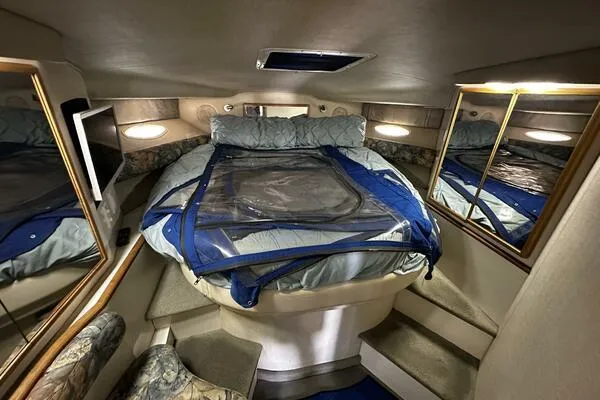 Slide: The Image of 1996 Sea Ray 400 Express Cruiser cabin with bed, mirrors, and cozy lighting. - 42