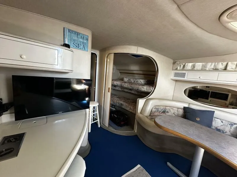 Slide: The Image of Interior of 1996 Sea Ray 400 Express Cruiser with modern amenities and cozy seating area. - 47