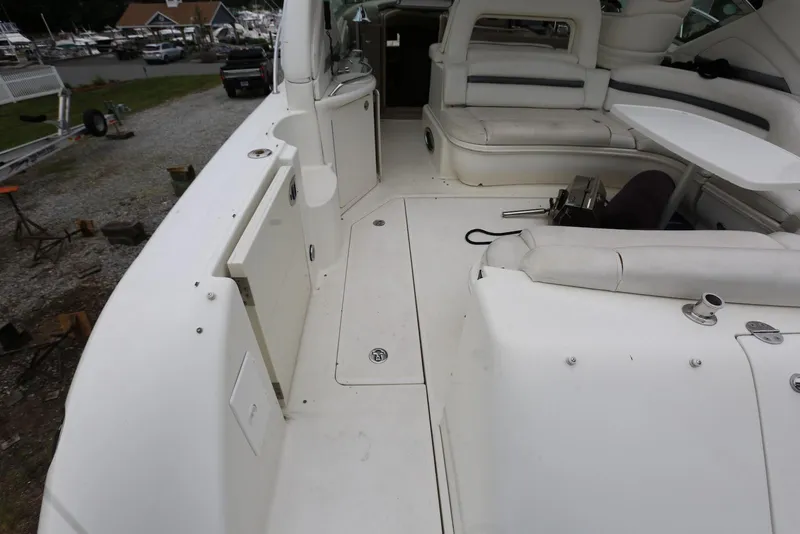 Slide: The Image of 2003 Sea Ray 420 Sundancer boat interior with white seating and table. - 13