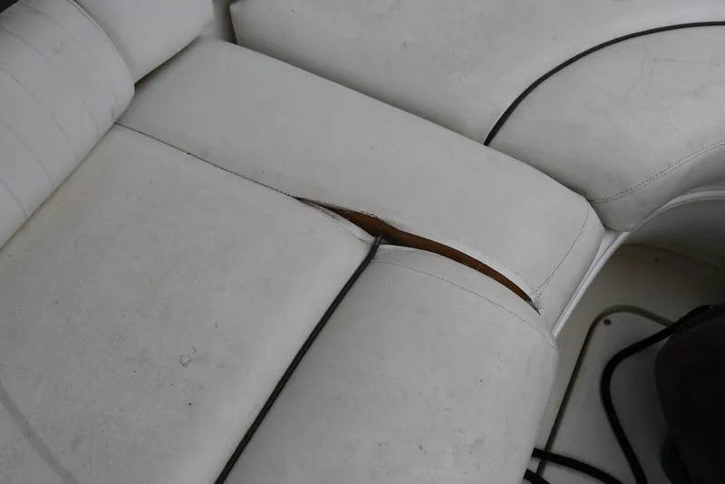 Slide: The Image of Torn white upholstery on 2003 Sea Ray 420 Sundancer boat seat. - 16
