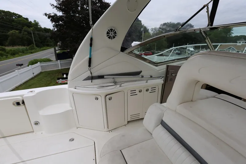 Slide: The Image of 2003 Sea Ray 420 Sundancer boat interior with seating and storage compartments. - 20