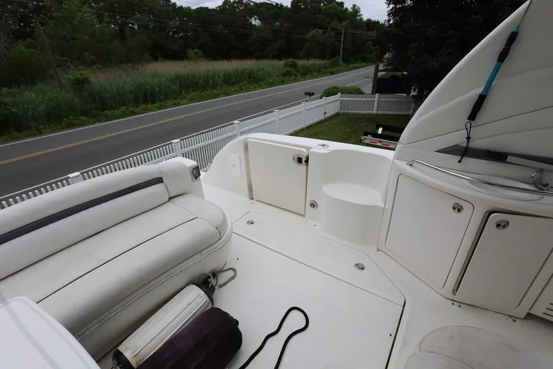 Slide: The Image of 2003 Sea Ray 420 Sundancer boat deck with seating and storage compartments. - 21