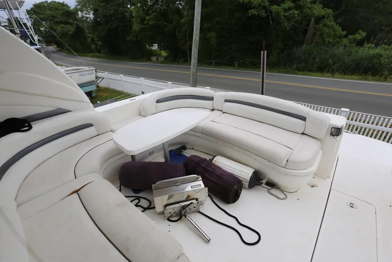 Slide: The Image of 2003 Sea Ray 420 Sundancer boat with white seating and table on deck. - 22
