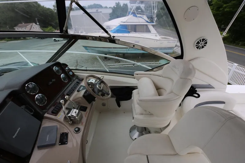 Slide: The Image of 2003 Sea Ray 420 Sundancer helm with luxurious seating and modern controls. - 25