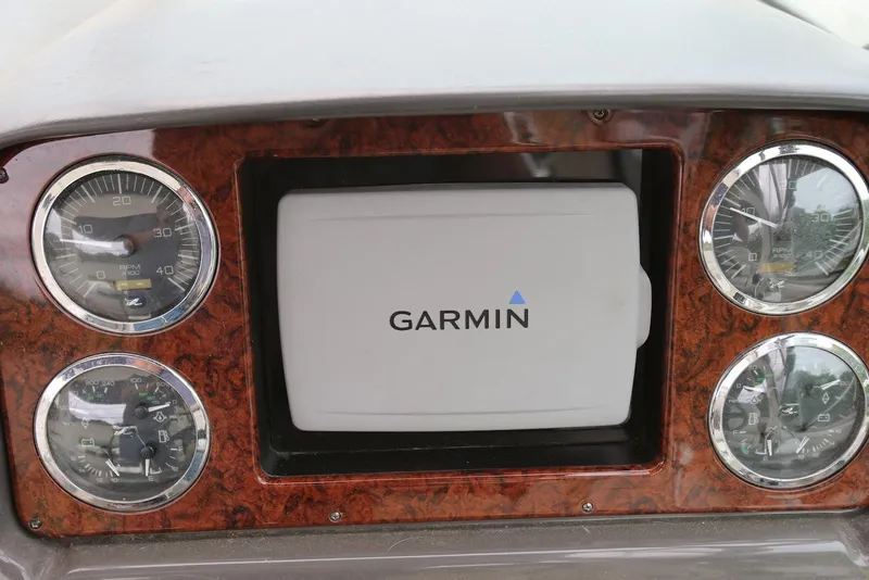 Slide: The Image of Dashboard of 2003 Sea Ray 420 Sundancer with Garmin display and gauges. - 27