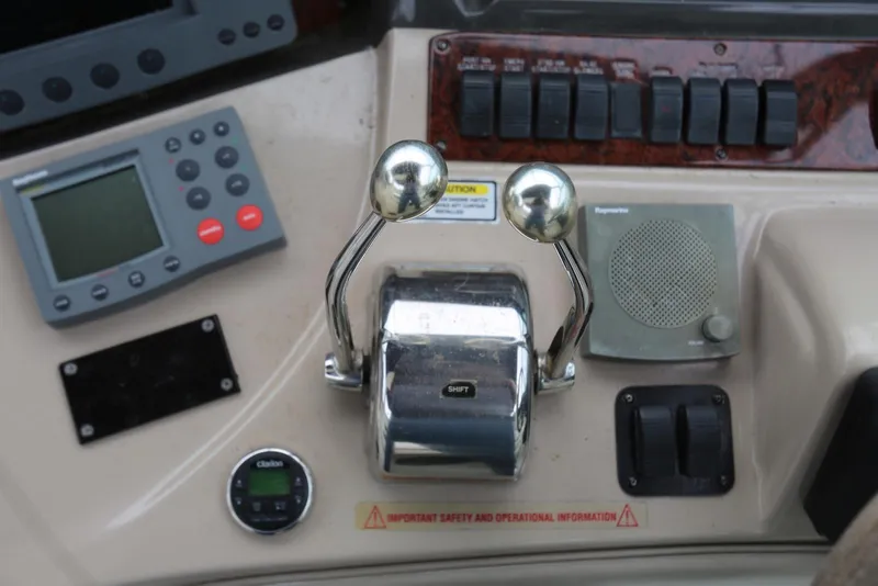 Slide: The Image of Control panel of a 2003 Sea Ray 420 Sundancer boat with throttle levers. - 31