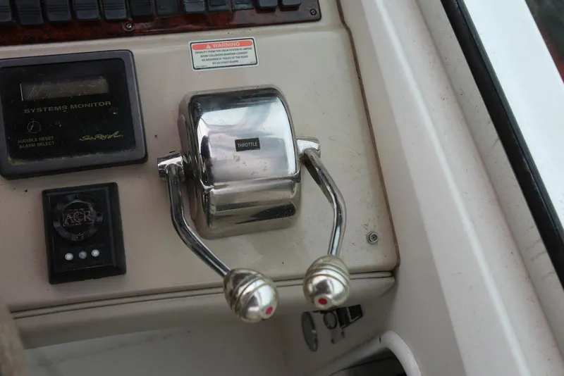 Slide: The Image of Throttle controls on a 2003 Sea Ray 420 Sundancer boat dashboard. - 32
