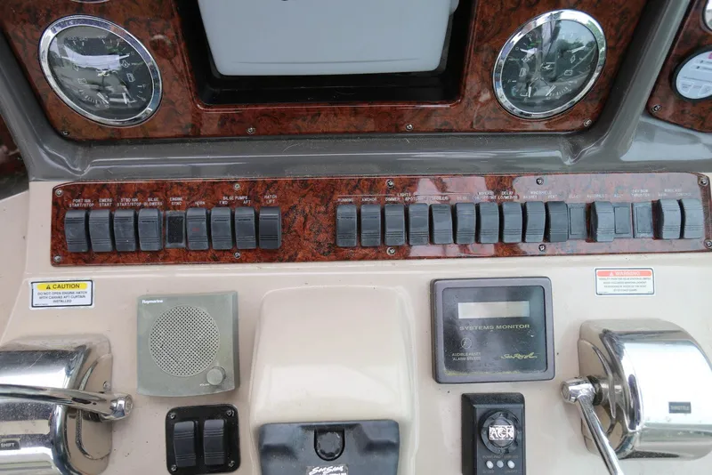 Slide: The Image of Control panel of a 2003 Sea Ray 420 Sundancer boat with switches and gauges. - 33