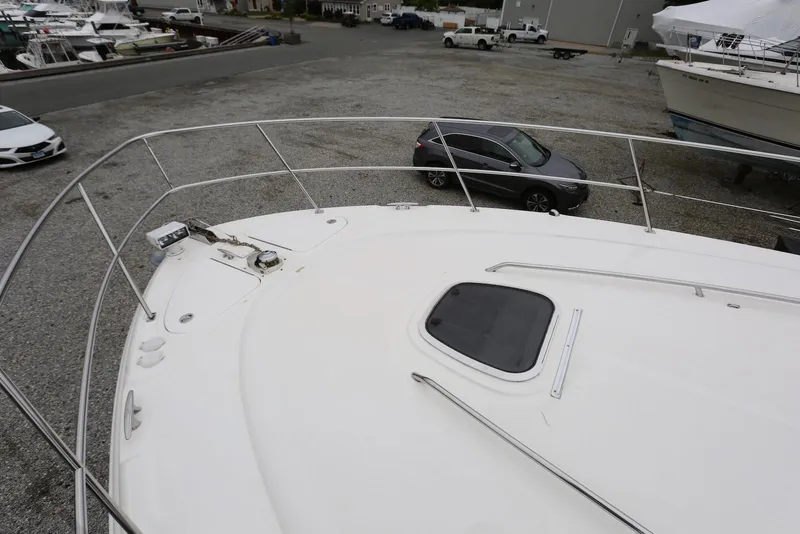 Slide: The Image of 2003 Sea Ray 420 Sundancer yacht deck view in a marina setting. - 41