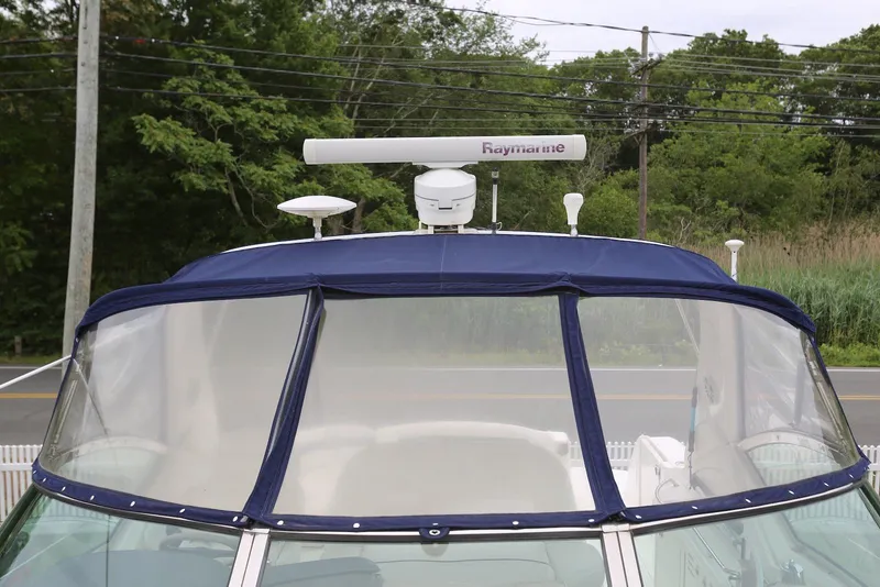 Slide: The Image of 2003 Sea Ray 420 Sundancer with blue canopy and Raymarine radar system. - 44