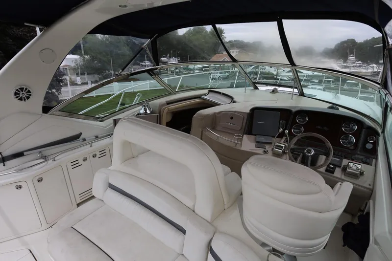 Slide: The Image of Interior view of 2003 Sea Ray 420 Sundancer yacht cockpit with steering wheel and controls. - 48