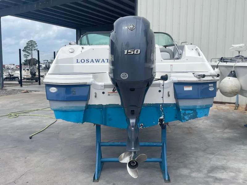 Slide: The Image of 2021 NauticStar 223 DC boat with Yamaha 150 outboard motor on a stand. - 11