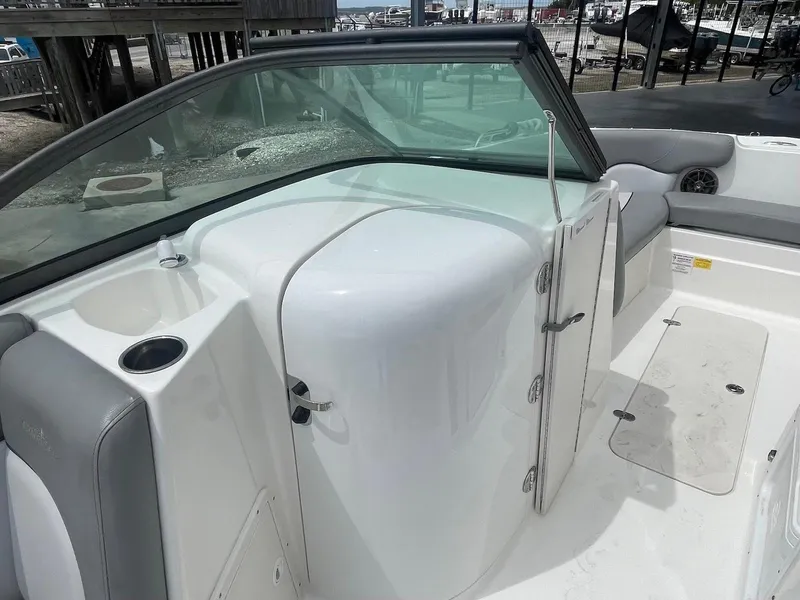 Slide: The Image of 2021 NauticStar 223 DC boat interior with seating and storage compartments. - 8