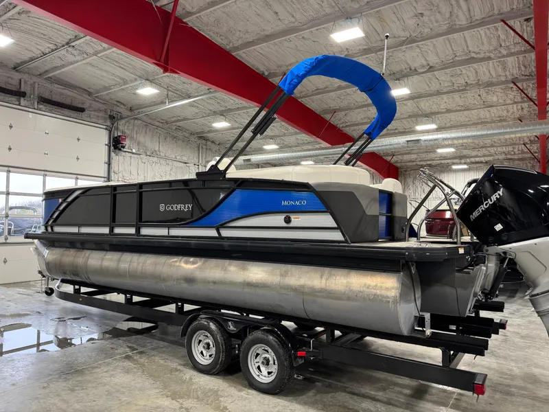 Slide: The Image of 2020 Godfrey 250 Monaco pontoon boat on trailer in indoor showroom. - 3
