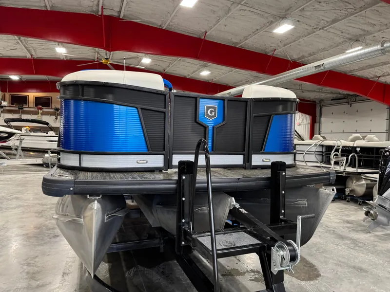 Slide: The Image of 2020 Godfrey 250 Monaco pontoon boat in a showroom with red ceiling accents. - 5